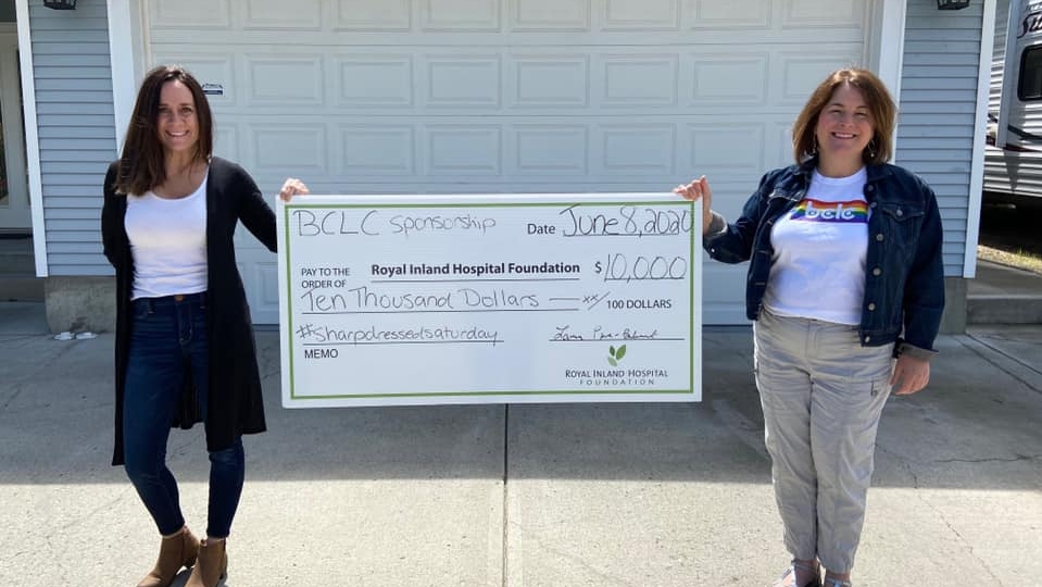 RIHF and BCLC representatives posing in front of large cheque