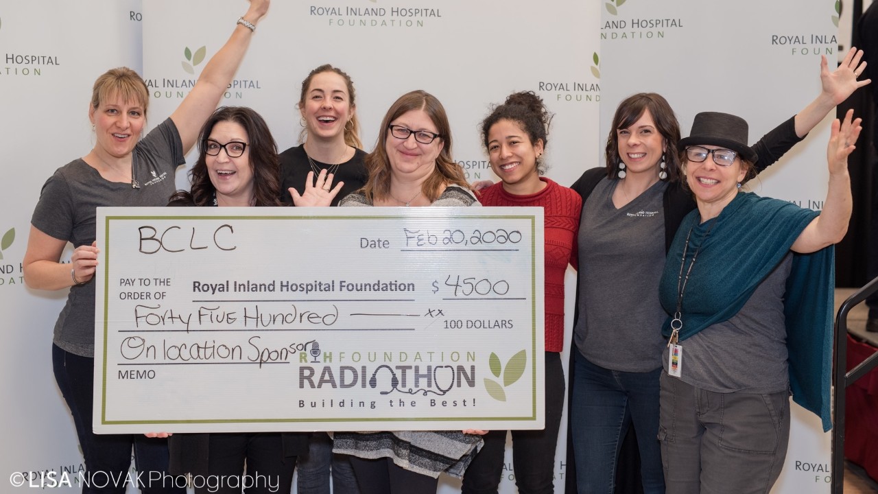 RIHF and BCLC representatives holding large cheque