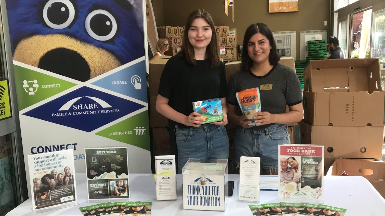 SHARE representatives posing at donation booth