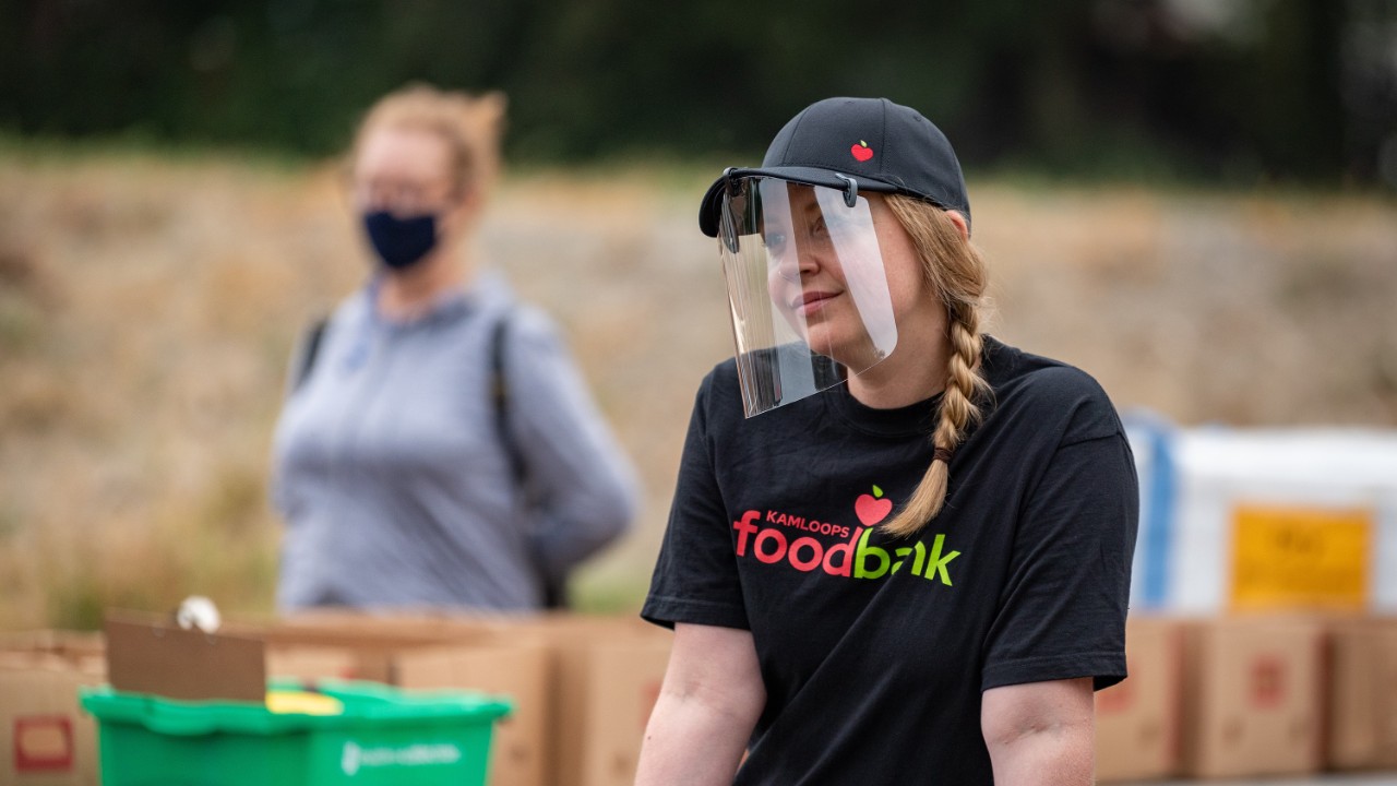 Food bank volunteer wearing a face shield