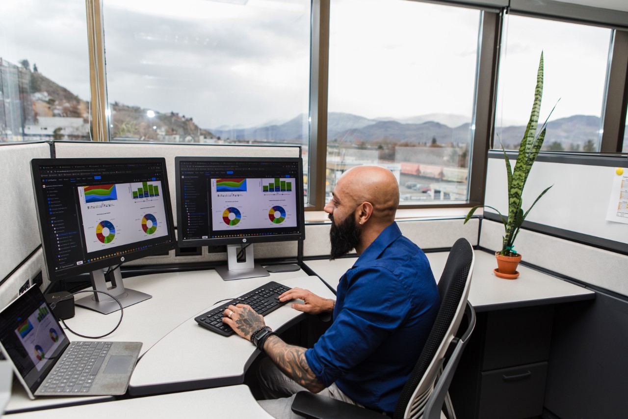 Man working at desk with two monitors