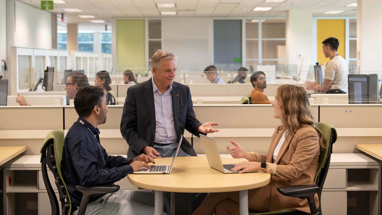 Employees looking at a computer together.