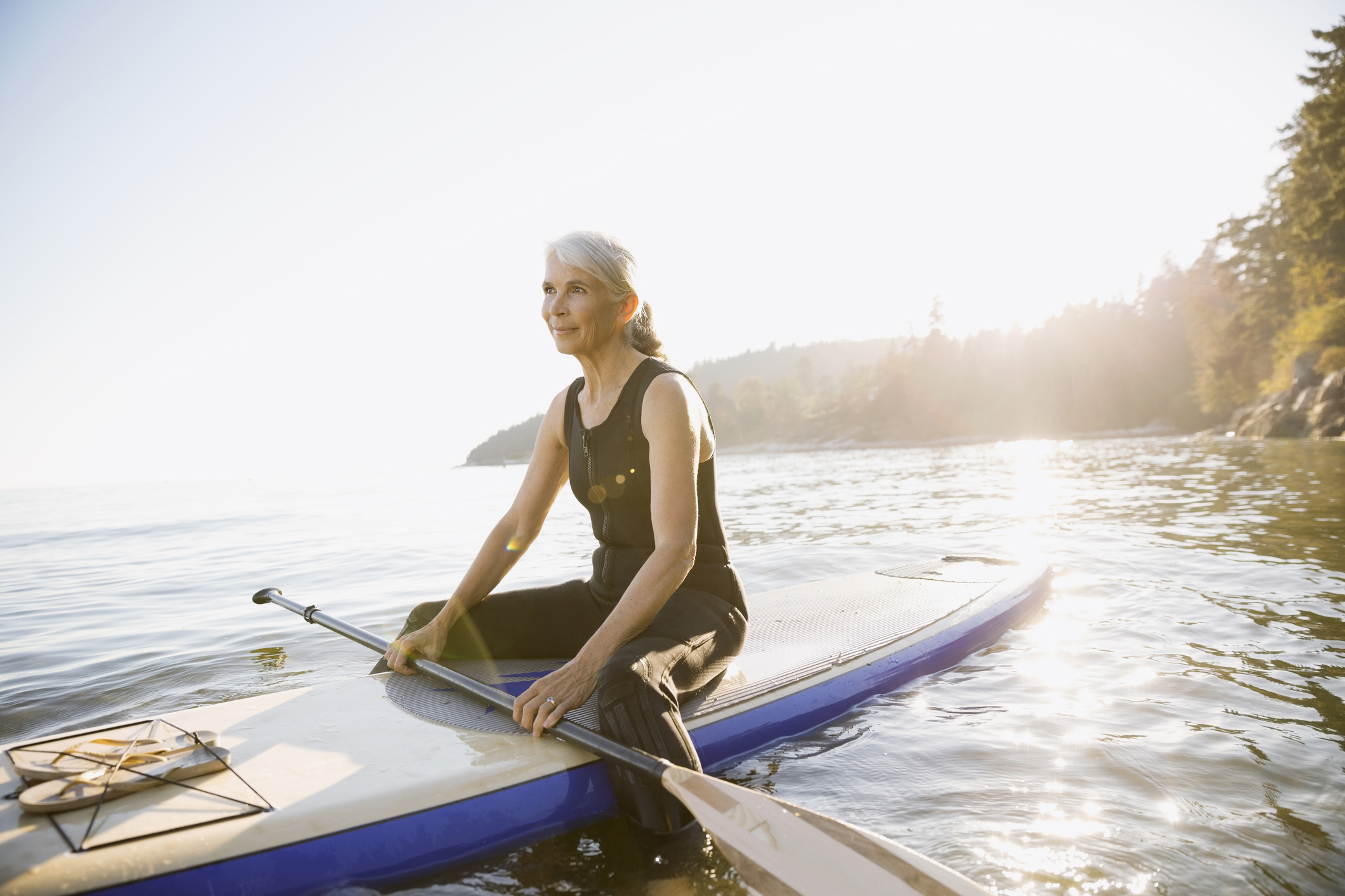 Sitting on a paddle board