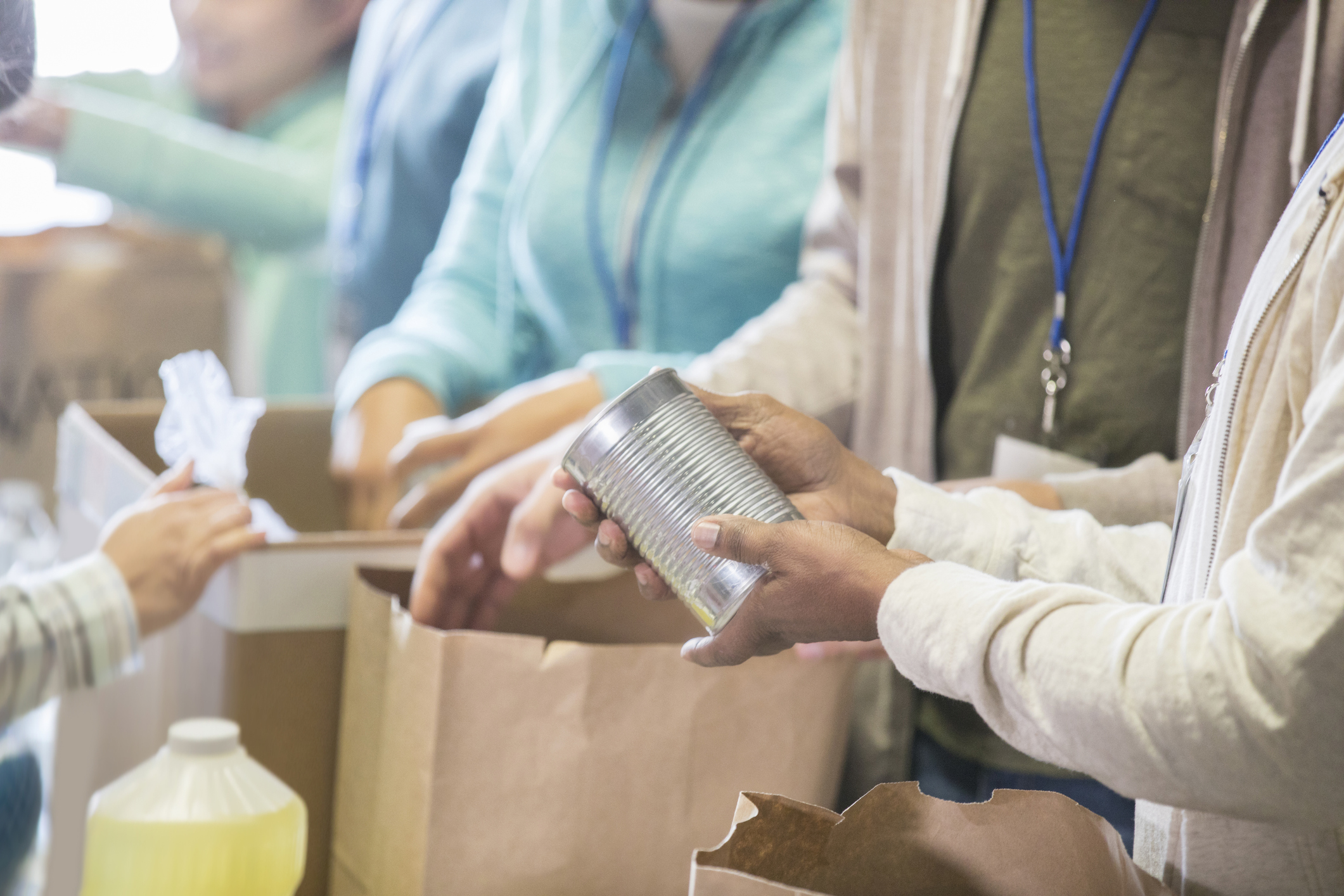 People helping sort canned food