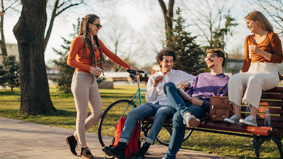 People sitting on a park bench together