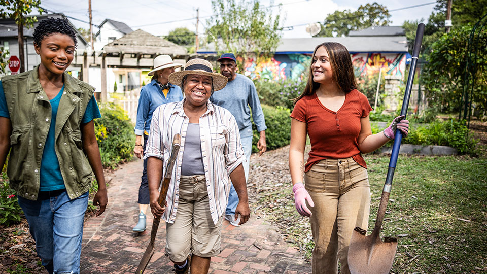 Illustration of person pushing wheelchair outside a hospital