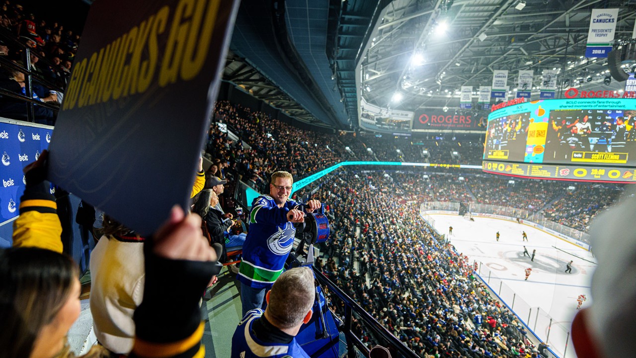 photo of community hero cranking the siren at the Vancouver Canucks game.